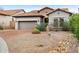 Charming home featuring stone accents, desert landscaping, and a brick-paved driveway at 6959 E Red Hawk Cir, Mesa, AZ 85207