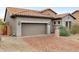 A well maintained garage on a house with a tile roof and a brick paver driveway at 6959 E Red Hawk Cir, Mesa, AZ 85207