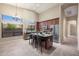 Bright eat-in kitchen boasts stainless appliances, center island with seating and a large window view at 6959 E Red Hawk Cir, Mesa, AZ 85207