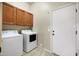 Laundry room with overhead cabinets and a full sized washer and dryer at 6959 E Red Hawk Cir, Mesa, AZ 85207