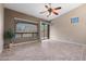 Bright living room with large windows, neutral tones, tile floors, and sliding glass door at 6959 E Red Hawk Cir, Mesa, AZ 85207