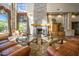 Inviting lounge featuring soaring ceilings, stone fireplace, and comfortable leather seating at 6959 E Red Hawk Cir, Mesa, AZ 85207