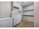 Large walk-in closet featuring installed shelving and dressers in a neutral color palette at 6959 E Red Hawk Cir, Mesa, AZ 85207