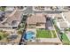 Aerial view of a backyard featuring a custom pool, hot tub, large grass area, and mature landscaping at 8615 S 45Th Gln, Laveen, AZ 85339