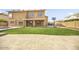 Lush backyard with green grass, basketball hoop, and covered patio at 8615 S 45Th Gln, Laveen, AZ 85339
