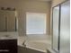 Bright bathroom featuring a soaking tub, a separate shower stall, and a vanity at 8615 S 45Th Gln, Laveen, AZ 85339