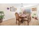 Formal dining room with wood-look tile floors, a chandelier, and a large window at 8615 S 45Th Gln, Laveen, AZ 85339