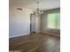 Inviting dining room with wood-look floors, modern chandelier, and natural light for elegant meals at 8615 S 45Th Gln, Laveen, AZ 85339
