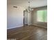 Inviting dining room with wood-look floors, modern chandelier, and natural light for elegant meals at 8615 S 45Th Gln, Laveen, AZ 85339