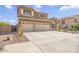 Well maintained two story home with three car garage, desert landscaping, and a driveway at 8615 S 45Th Gln, Laveen, AZ 85339