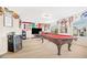 Game room features a billiard table, mini fridge, and a large screen television at 8615 S 45Th Gln, Laveen, AZ 85339