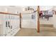 Curved stairway with wooden handrail and white spindles leads to the second story at 8615 S 45Th Gln, Laveen, AZ 85339
