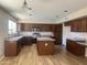 Modern kitchen featuring granite counters, stainless appliances, and a convenient center island at 8615 S 45Th Gln, Laveen, AZ 85339