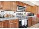 Kitchen with stainless steel appliances, granite countertops, and wood cabinets at 8615 S 45Th Gln, Laveen, AZ 85339