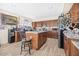 Spacious kitchen features wooden cabinets, an island with bar stool, and wood-look floors at 8615 S 45Th Gln, Laveen, AZ 85339