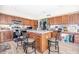 Well-equipped kitchen with wood cabinets, granite countertops, and a center island with seating at 8615 S 45Th Gln, Laveen, AZ 85339