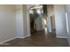Open-concept living room with wood-look floors that leads to a beautiful staircase with an archway at 8615 S 45Th Gln, Laveen, AZ 85339