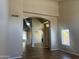 Bright living room with wood-look floors and archways creating an open and inviting space for entertaining at 8615 S 45Th Gln, Laveen, AZ 85339