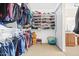 Organized walk-in closet with shelves for shoes, hats and hanging clothes, maximizing storage at 8615 S 45Th Gln, Laveen, AZ 85339