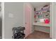 Bathroom area with pink door, vanity area and built-in shelving at 8749 W Clarendon Ave, Phoenix, AZ 85037