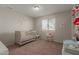 This bedroom has a crib, window and is decorated with wall art at 8749 W Clarendon Ave, Phoenix, AZ 85037