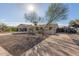 Single-story home featuring desert landscaping and a long concrete driveway at 8749 W Clarendon Ave, Phoenix, AZ 85037