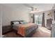 Spacious bedroom with ceiling fan, sliding glass doors to the pool area and neutral decor at 8749 W Clarendon Ave, Phoenix, AZ 85037