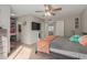 This bedroom has carpet, a television and an ensuite bathroom at 8749 W Clarendon Ave, Phoenix, AZ 85037