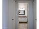 Bathroom entrance with closet door, tiled floors, mirror, and sink with cabinets at 9450 N 94Th Pl # 215, Scottsdale, AZ 85258