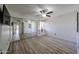 Bright bedroom boasting light wood floors, a ceiling fan, and sliding mirror closet doors at 9450 N 94Th Pl # 215, Scottsdale, AZ 85258