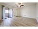 This bright bedroom features new floors, a ceiling fan and a sliding door to a patio at 9450 N 94Th Pl # 215, Scottsdale, AZ 85258