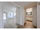 Open bedroom doorway showcasing wood floors, fan, and mirrored closet doors at 9450 N 94Th Pl # 215, Scottsdale, AZ 85258