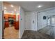 Inviting interior view of a well-lit entryway leading to a modern kitchen and a comfortable living space at 9450 N 94Th Pl # 215, Scottsdale, AZ 85258