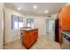 Eat-in kitchen area featuring a central island, tile floors, and sliding windows at 9450 N 94Th Pl # 215, Scottsdale, AZ 85258