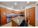 Updated kitchen with wood cabinets, stainless steel appliances, and an island with seating for casual dining at 9450 N 94Th Pl # 215, Scottsdale, AZ 85258