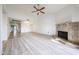 Bright living room with vaulted ceiling, tile fireplace and wood-look floors at 9450 N 94Th Pl # 215, Scottsdale, AZ 85258