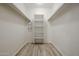 Walk-in closet features new floors, built in shelves, and hanging racks at 9450 N 94Th Pl # 215, Scottsdale, AZ 85258