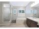 Elegant bathroom offers soaking tub, walk-in shower, and marble-style tile at 24437 N 94Th Ave, Peoria, AZ 85383