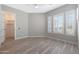 Bedroom includes wood-style flooring, plantation shutters, and doorway to closet at 24437 N 94Th Ave, Peoria, AZ 85383