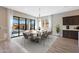 Elegant dining room with sliding glass doors to the outdoor patio and a patterned rug at 24437 N 94Th Ave, Peoria, AZ 85383