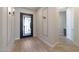 The foyer offers a view of the custom front door with a unique geometric pattern at 24437 N 94Th Ave, Peoria, AZ 85383