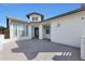 The front entryway is complete with a stone paver patio and modern exterior lighting at 24437 N 94Th Ave, Peoria, AZ 85383