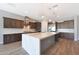 Updated kitchen boasts an island with stone countertops and stainless-steel appliances at 24437 N 94Th Ave, Peoria, AZ 85383