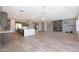Open-concept living room with wood tile floors, modern fireplace, and elegant chandelier at 24437 N 94Th Ave, Peoria, AZ 85383