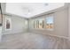 Bright living room features wood-style flooring, plantation shutters, and neutral paint at 24437 N 94Th Ave, Peoria, AZ 85383