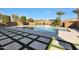 Backyard oasis features a sparkling pool, raised spa, grass turf and mature landscaping at 24437 N 94Th Ave, Peoria, AZ 85383