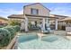 Backyard features a swimming pool, patio dining area, and lush green landscaping at 10134 W Cashman Dr, Peoria, AZ 85383