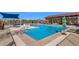 Large community pool area with plenty of lounge chairs, shaded seating and umbrellas at 10134 W Cashman Dr, Peoria, AZ 85383