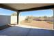 Covered patio that looks out to a low maintenance backyard with gravel and some bushes at 1075 W Avalon Canyon Dr, Casa Grande, AZ 85122