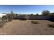 View of the backyard with gravel and a block wall at 1075 W Avalon Canyon Dr, Casa Grande, AZ 85122